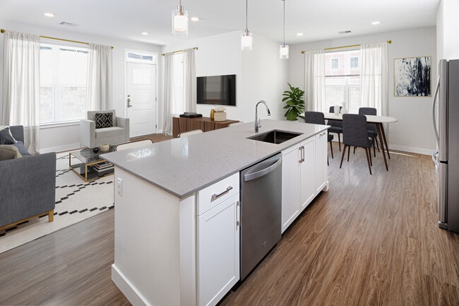 Phase II Renovated Package I apartment kitchen, dining, and living room with hard surface flooring