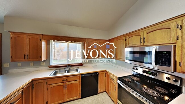 Photo - Enjoy this 3-bedroom home featuring a fully equipped kitchen, a two-car attached garage, and a fe...