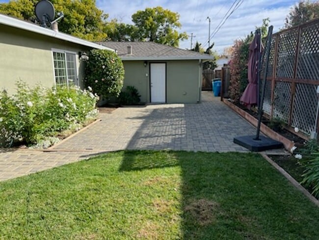 Photo - Beautiful updated home with all stainless steel appliances, hardwood floors throughout, and a lar...