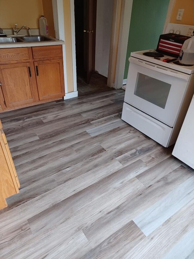 Kitchen with updated floor and energy-efficient fridge - 2432 Prais St
