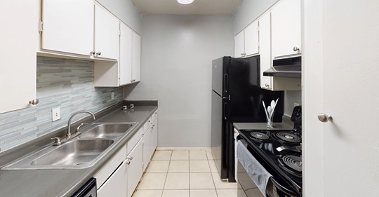 Kitchen with new backsplash - The New Horizon Apartments