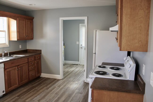 Kitchen leading to laundry room. - 310 Chestnut Alley Apartment Unit 310 Chestnut Alley