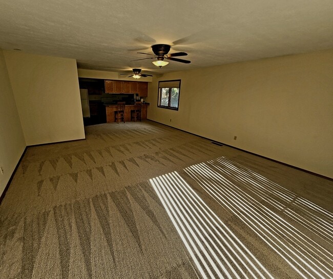 Living room facing kitchen - 1711 W Koch St Unit Cedarwinds #34
