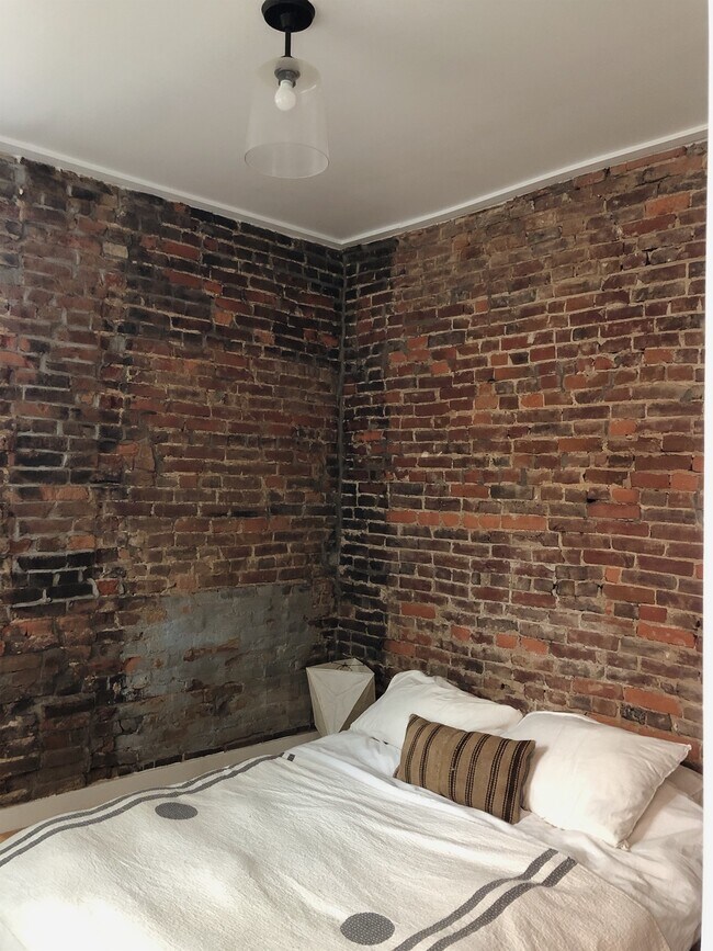 Exposed brick bedroom - 1713 Locust St Unit 1