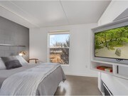 Bedroom with built-in TV turntable and shelves