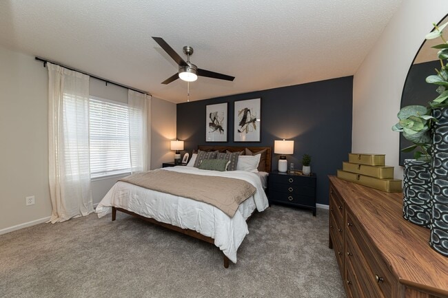 Cozy bedroom with carpet and overhead lighting