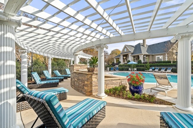 Spacious poolside sundeck with lounge chairs at Hawthorne at the Carlyle in Greenville, SC - Hawthorne at the Carlyle