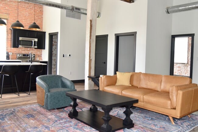 Open concept living, spacious living, room, kitchen and dining area - 101 W Broadway St Apartments