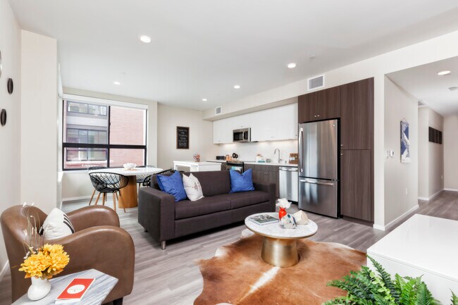 Living and dining area with hard surface flooring and open concept kitchen with stainless steel appliances - Avalon Dogpatch