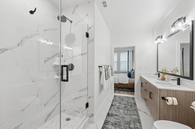 Bathroom with Quartz Countertops, Double Vanity Sinks, Walk-in Shower, and Walk-in Closet - Linz Bayview