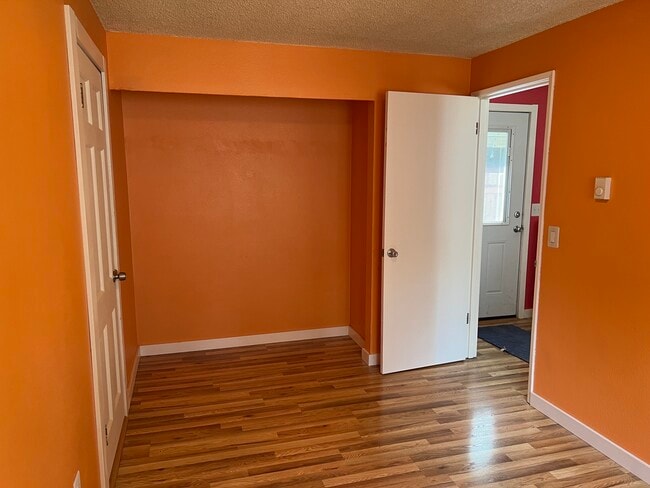 Orange bedroom. Door on right goes to living room. Door on left goes to garage. - 1618 Groves Ave NW