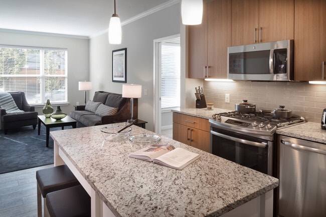 Traditional Collection Kitchen with oak cabinetry, beige tile backsplash, grey granite countertops, stainless steel appliances, and hard surface flooring