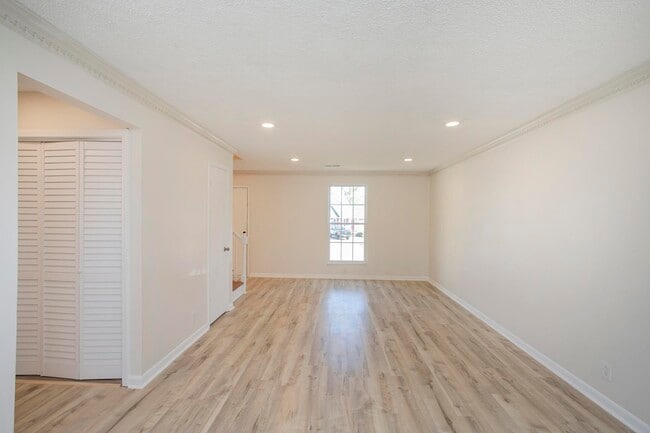 living room featuring beautiful wood flooring and abundant natural light. - 105 Jacksons Retreat Ct