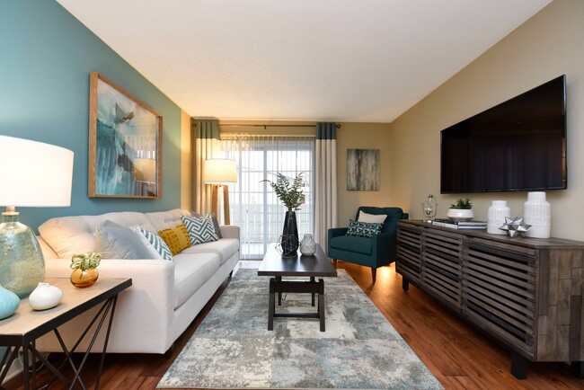 Living Room with Hardwood Style Flooring - Hampton Creek Apartments