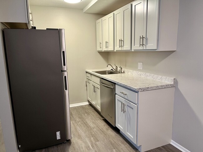 Renovated Kitchen with White Shaker Cabinets - Mill Park Apartments