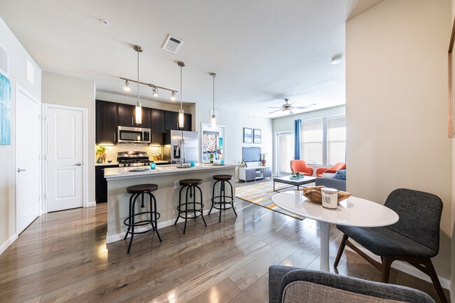 Kitchen, living, and dining area with hard surface flooring - Avalon Wolf Ranch