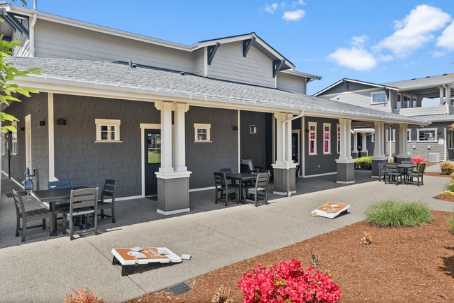 Relax and unwind in this inviting outdoor patio, complete with comfortable seating and fun lawn games.