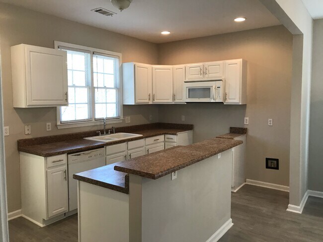 Kitchen. Refrigerator, range, microwave, dishwasher are included. - 345 Andrew J Hairston Blvd NW