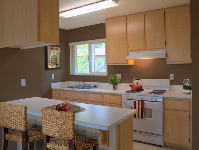 Classic Package I kitchen with white appliances, oak cabinetry, and white laminate countertops