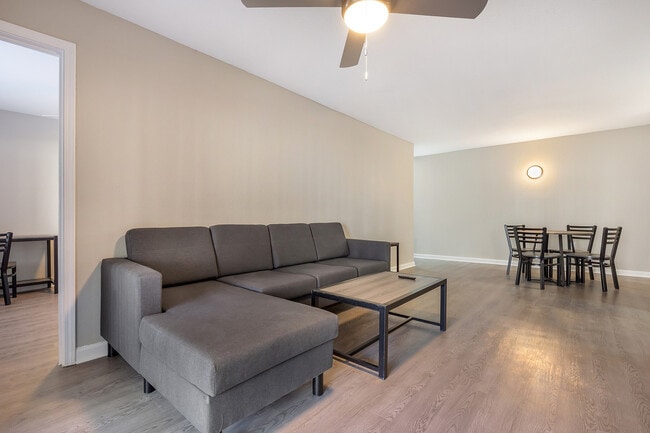 Explore this bright and airy living room perfect for modern living. - Village Green Student Housing