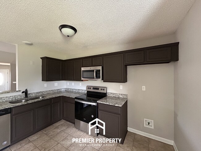 Photo - Modern 3BR/2BA in 38125 | Vaulted Ceilings, Stone Fireplace & 2-Car Garage