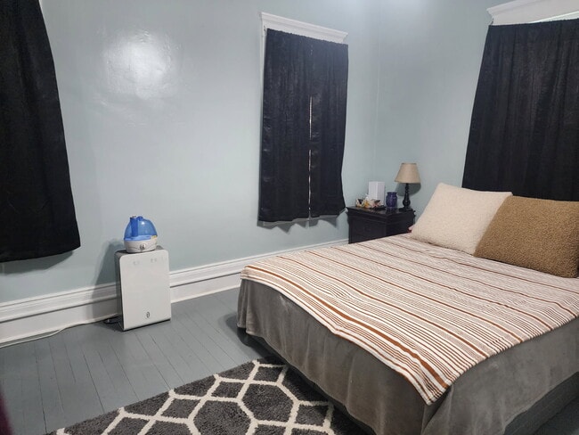 Bedroom 1 (larger bedroom). - 89 S Main St Unit ApartmentA