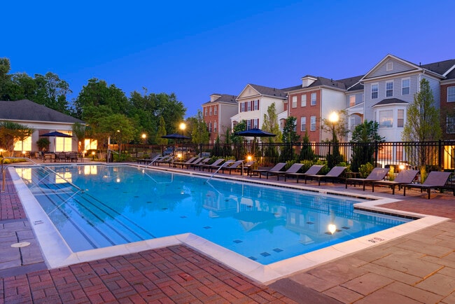 Swimming pool and sundeck with lounge seating - Avalon at Traville Apartments