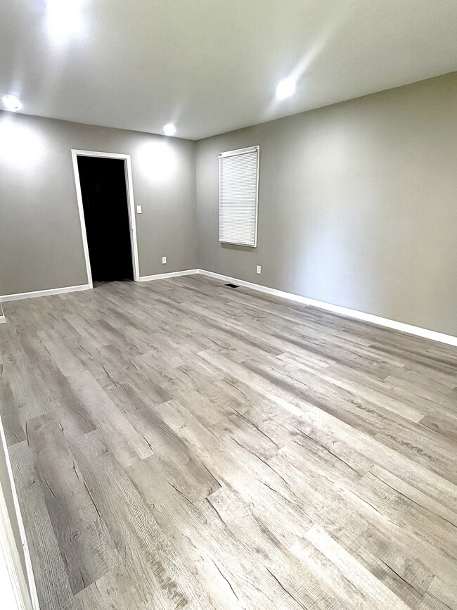 Living Room - modern luxury vinyl plank flooring and neutral paint. - 125 Trio Ln Unit A
