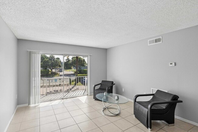 Step into the inviting living space at Clear Lake Palms Apartments, showcasing open layouts and modern finishes. Enjoy natural light flooding through wide windows and stylish design. Schedule a tour today to see your future home!