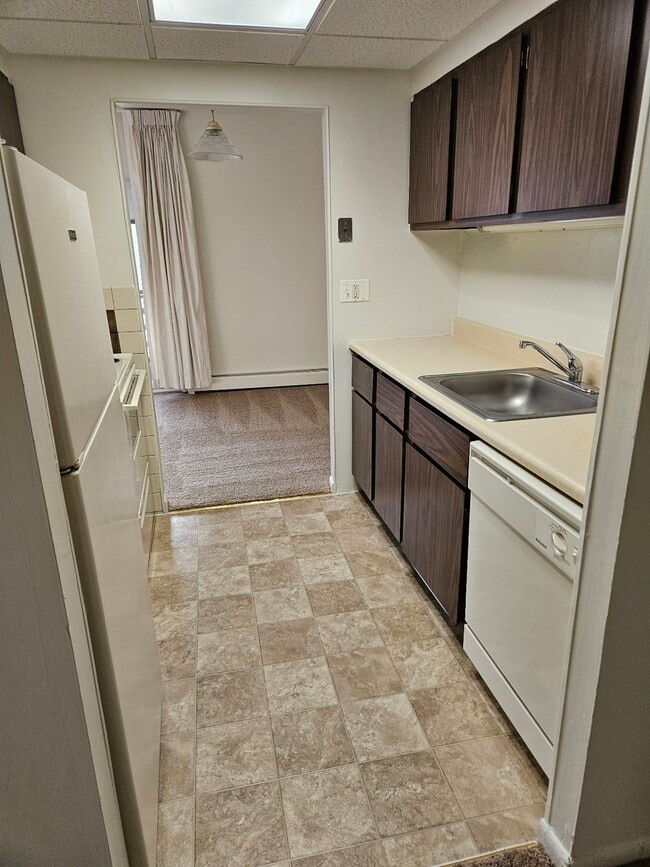 Step into this cozy kitchen, perfect for culinary creativity and intimate meals. - Lake Club Apartments
