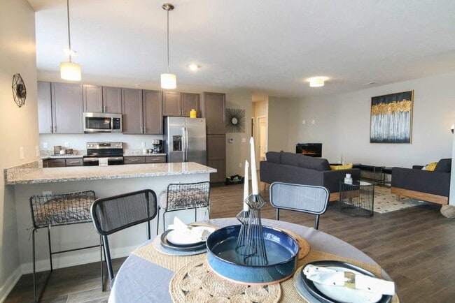 Our open-concept living and dining spaces are designed for modern living, with high-end finishes and thoughtful details. - WH Flats