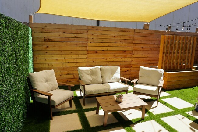 Shade provided over the backyard paver stone sitting area - 5230 Brinkman Ct