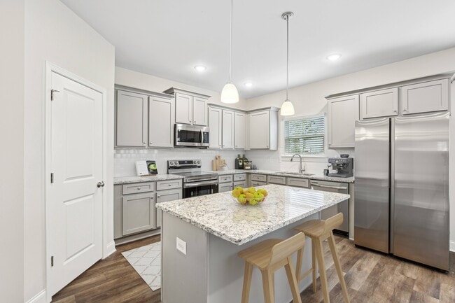 Another view of the spacious kitchen and stainless steel appliances
