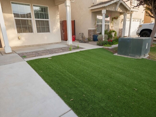 Photo - Spacious 4-Bedroom Home with Solar, Finished Garage, Large Pantry & Low-Maintenance Backyard in M...