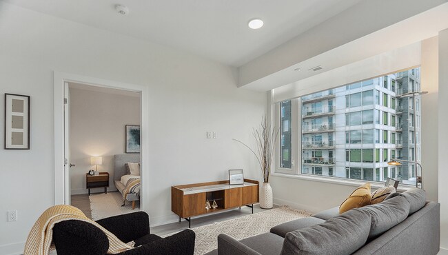 Latitude Living Room With Windows And Entrance to Primary Bedroom - Latitude
