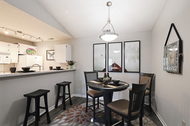 Bright dining area with open kitchen layout—perfect for everyday meals or entertaining guests.