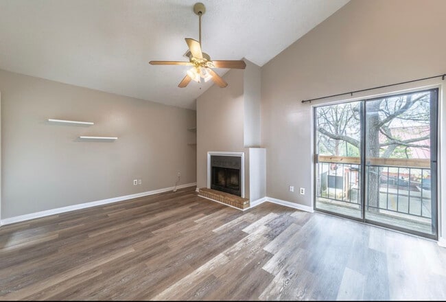 Living area with fireplace and balcony. - 913 St Landry St Unit #8