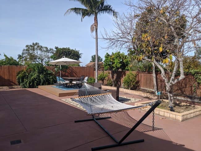 Private comfy backyard, with fire pit and hammock.