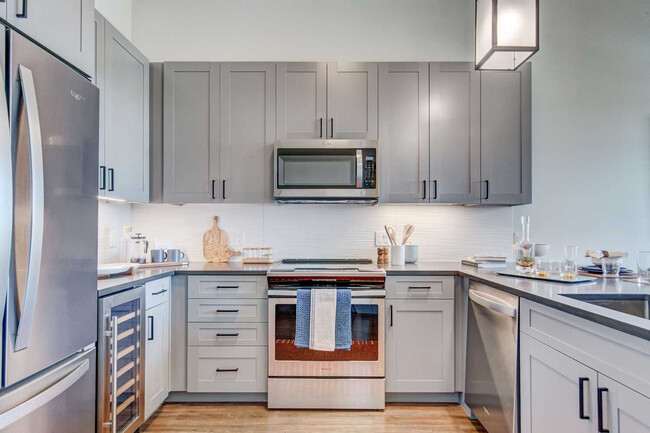 Kitchen with Wood-Style Flooring - Cortland Cap Hill Apartments