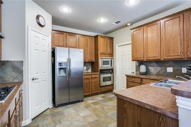 Photo - Immaculate home on a beautifully landscaped lot, tandem garage, plenty of storage!