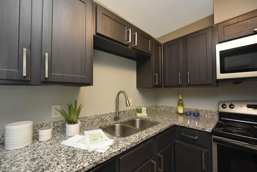 Kitchen with granite counters, stainless appliances, and modern cabinetry