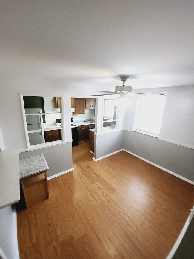 Dining room view into kitchen - 7629 Ivory Ave Apartments Unit 2F