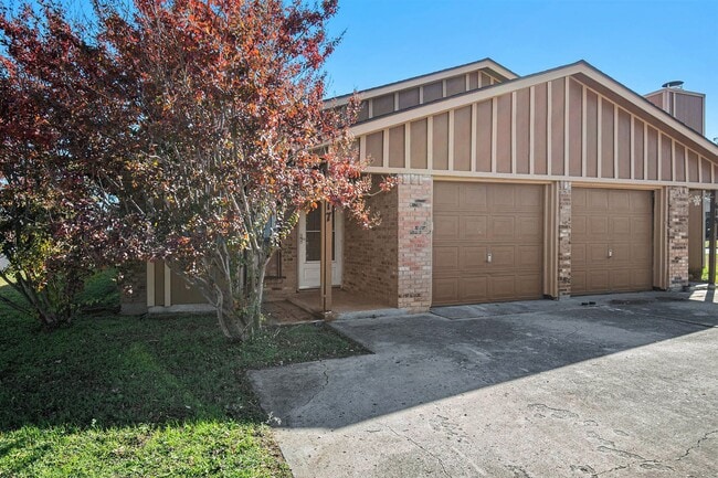 Photo - Modern duplex featuring three bedrooms and two bathrooms with an attached garage.