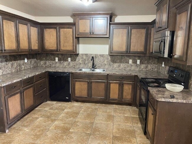 Photo - 3 bed 2 bath 2 car garage in Chickasha! granite, luxury vinyl and ready for move in!