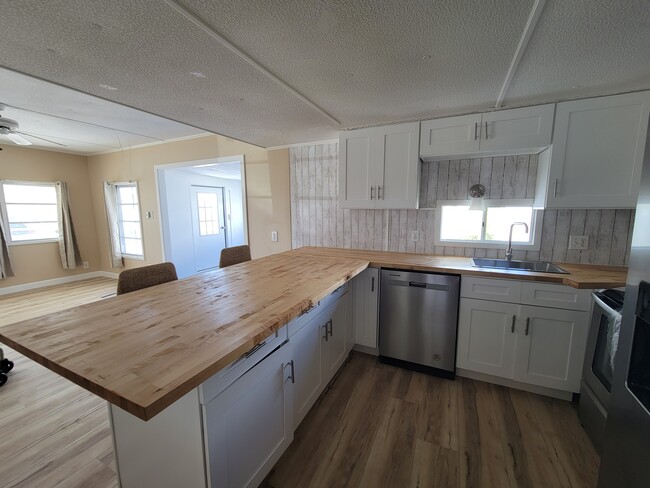 Brand new cabinets and butcher block countertops. - 9065 48th Ave N Rental