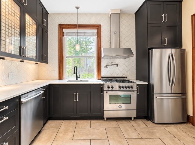 Updated kitchen with stainless appliances, ample cabinetry and gas range