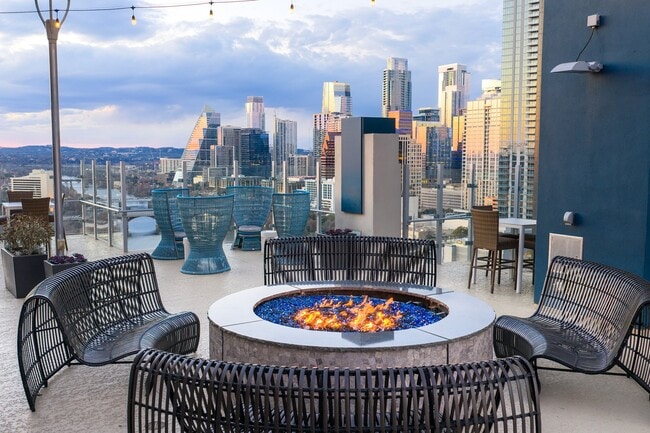 Rooftop lounge with large fire pit and Downtown Austin views