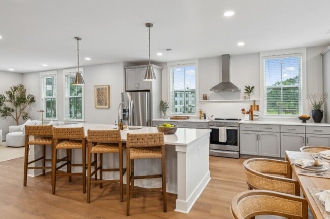 The stylish eat-in kitchen at Fenland Townhomes offers a spacious layout with a large island, high-e