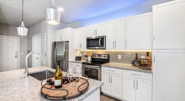 Modern Cabinetry with Designer Hardware and Title Backsplash - Cortland Reunion Apartments