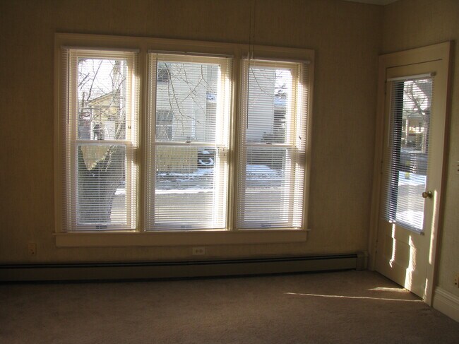 Living room with front door to right. - 100 Park Ave Unit 1